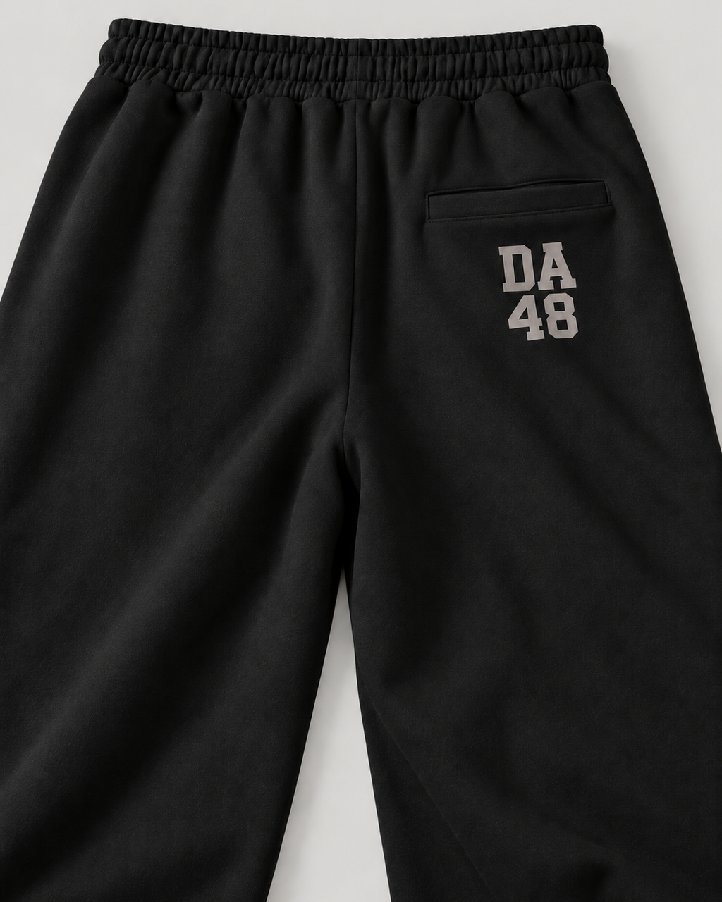 The Barrel Sweatpant in black, back print detail