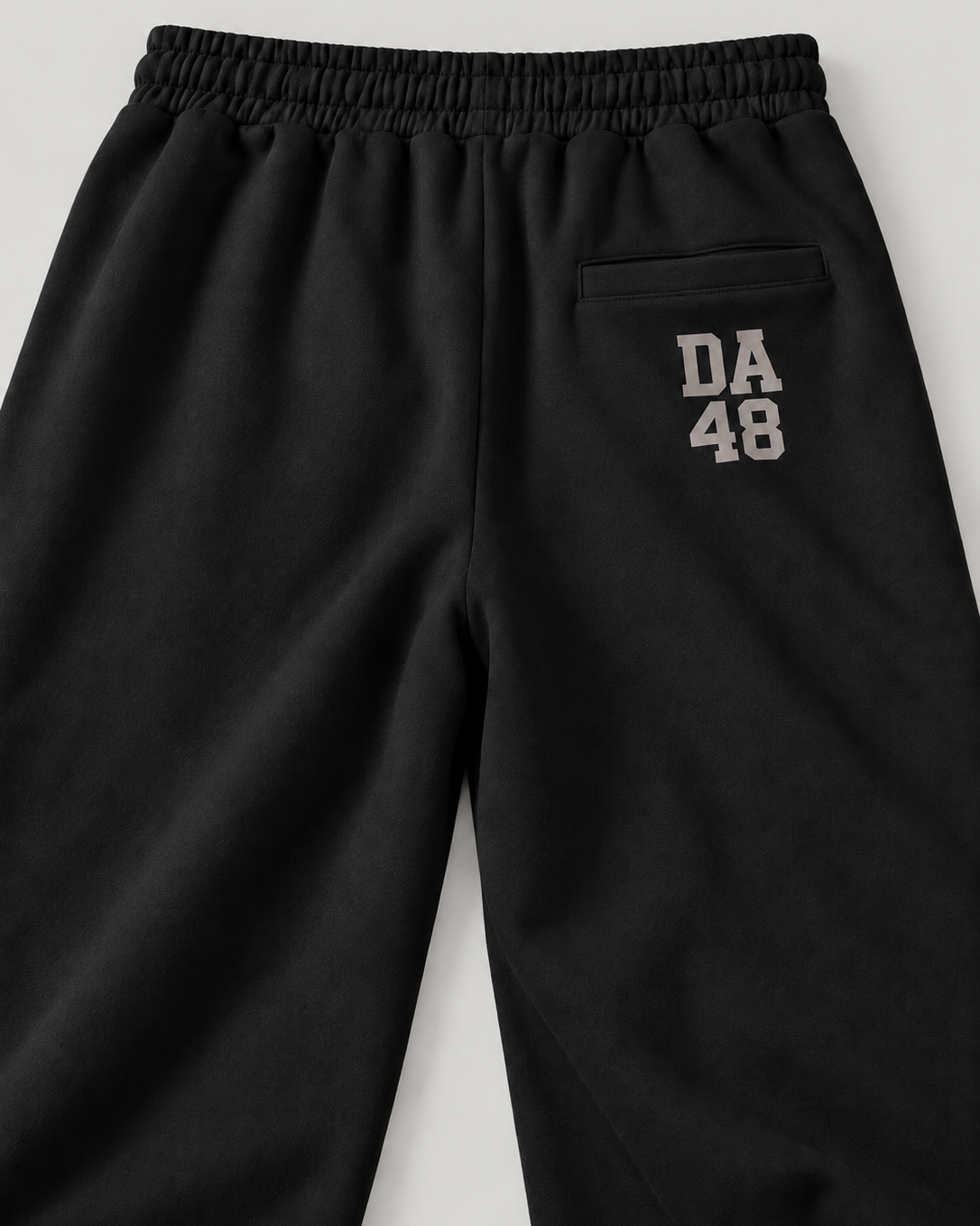 The Barrel Sweatpant in black, back print detail