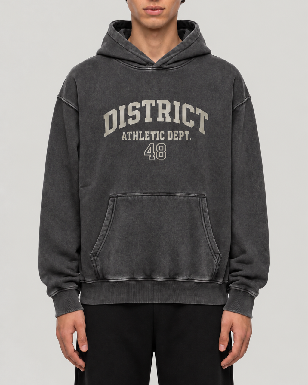The District Hoodie in charcoal, on model, front