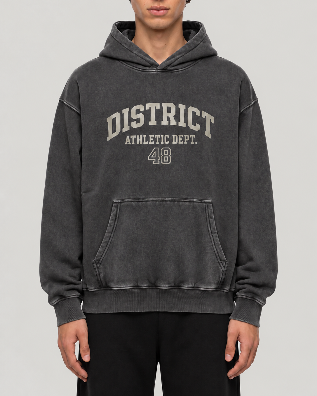 The District Hoodie in charcoal, on model, front