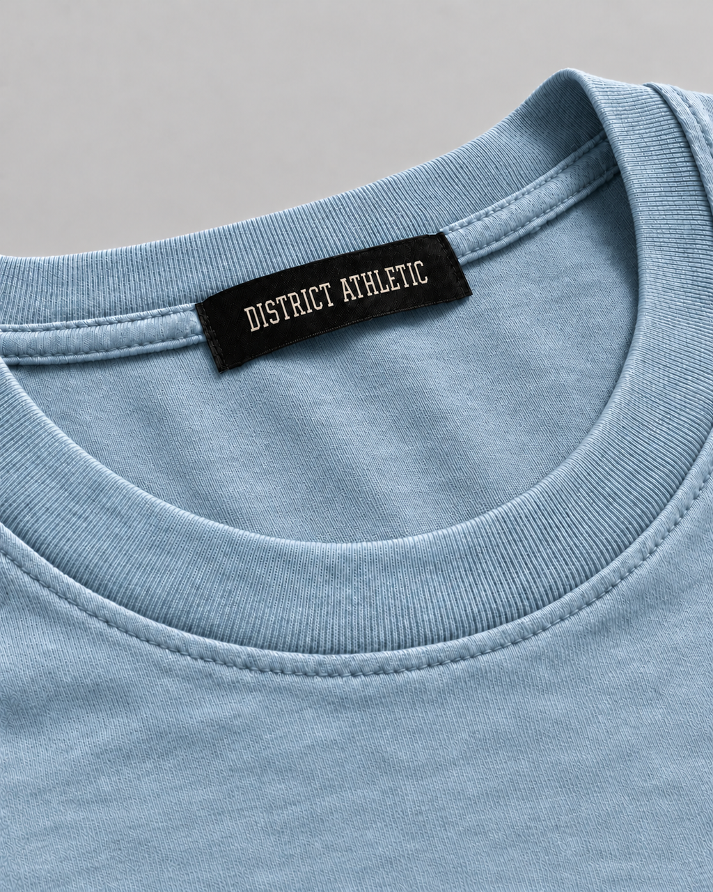 The Potomac Tee in blue with navy print, collar and label