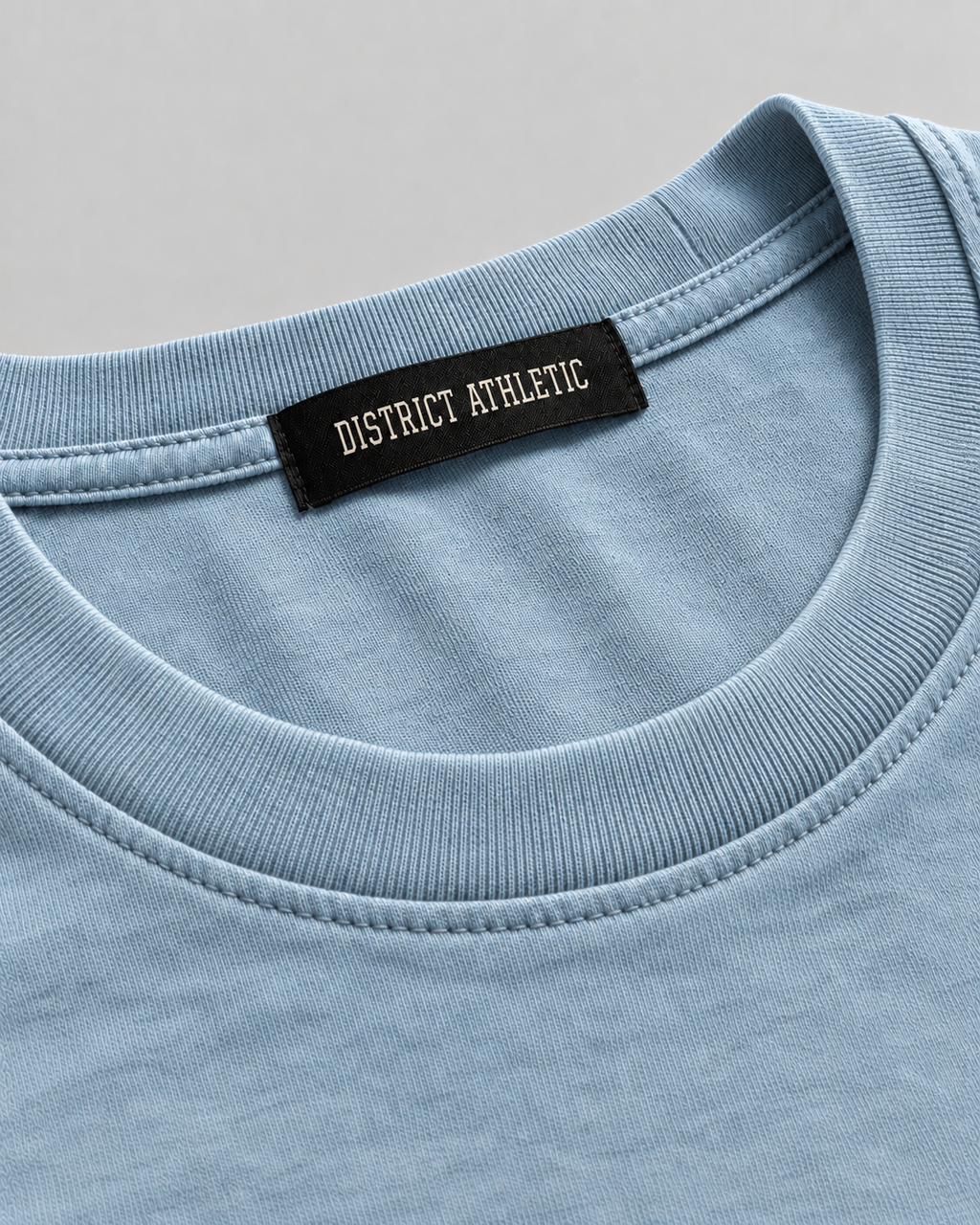 The Potomac Tee in blue with red print, collar and label