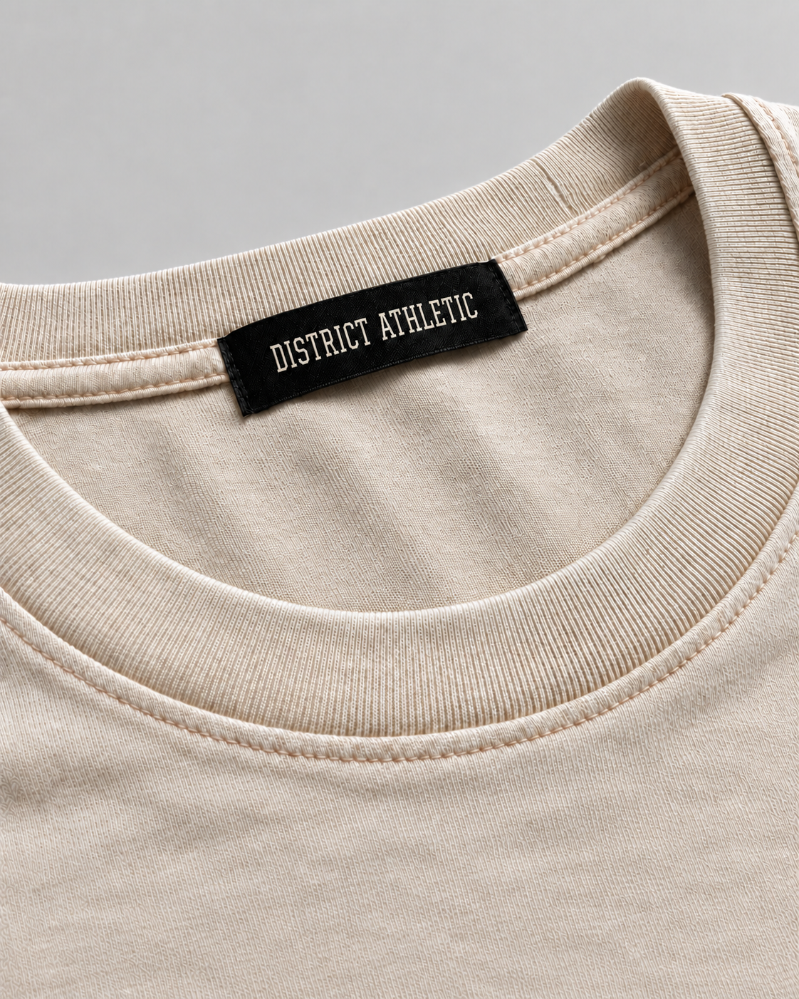 The Potomac Tee in sand with navy print, collar and label